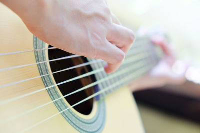 Close-up of hands playing guitar