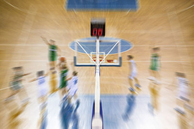 Blurred motion of players playing basketball