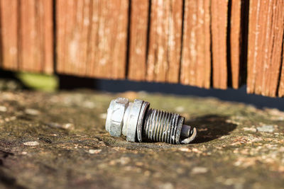 Close-up of metallic object against wall