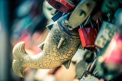 Close-up of dragon hanging on metal for sale