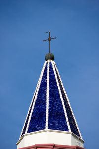 Low angle view of cross against clear blue sky