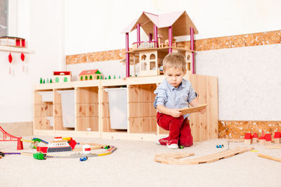 Boy playing with toy at home