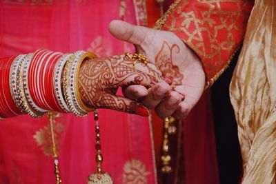 Midsection of couple during wedding ceremony