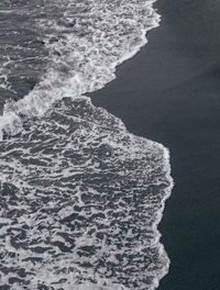 High angle view of waves on shore