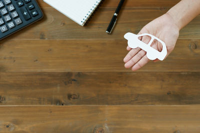 High angle view of person using mobile phone on table