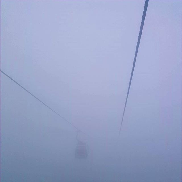 transportation, copy space, connection, clear sky, mode of transport, cable, power line, sky, electricity, indoors, low angle view, no people, day, built structure, weather, foggy, nature, reflection