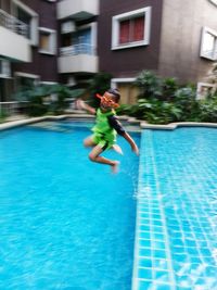 Man jumping in swimming pool