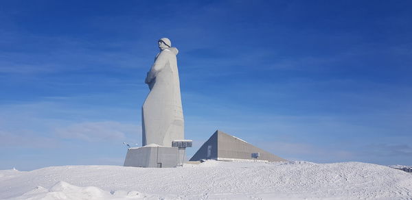 Low angle view of statue against blue sky