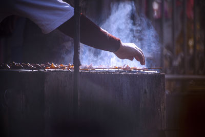 Midsection of man preparing food