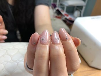 Midsection of woman showing nail art