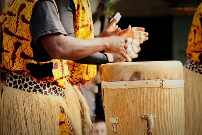 Midsection of musicians playing conga