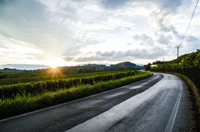 Road by landscape against sky