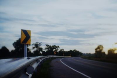 Road sign against sky