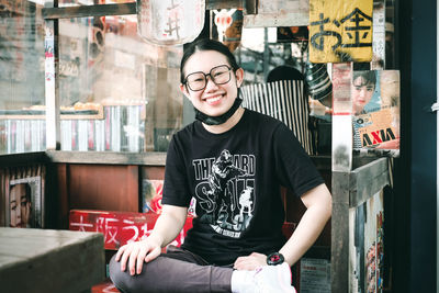 Portrait of young man standing in city