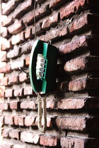 Landline phone hanging against wall