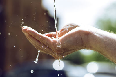 Close-up of water drops on hand