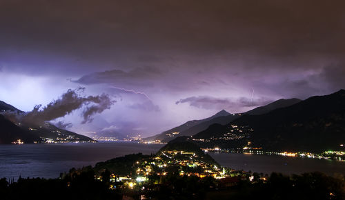 Panoramic view of illuminated mountains against sky at night