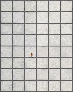 Aerial view of woman walking on tiled floor