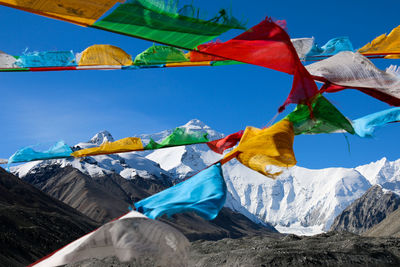 Spiritual buntings hanging on mountain against sky