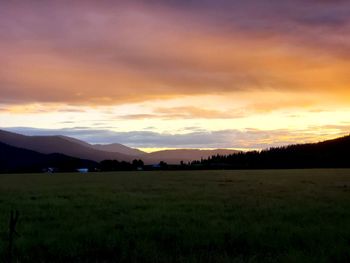 Scenic view of silhouette field against sky during sunset