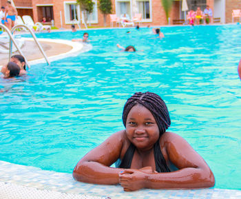 Portrait of young woman in swimming pool