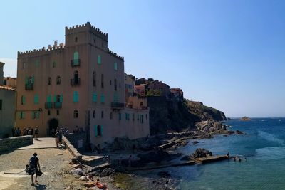 Panoramic view of sea and buildings against clear sky