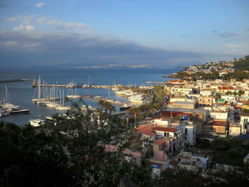 High angle view of town by sea against sky