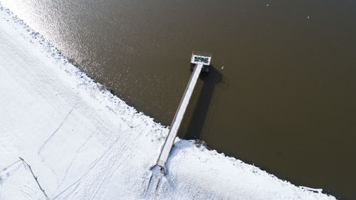 Aerial view of snow covered pier over sea