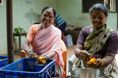 Portrait of a smiling young woman holding food