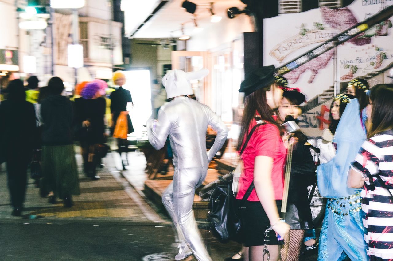 street, men, walking, person, building exterior, large group of people, built structure, lifestyles, architecture, city, city life, leisure activity, transportation, rear view, road, full length, umbrella, casual clothing, city street