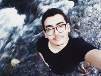 Portrait of man with reflection in water