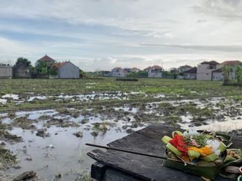 Scenic view of lake and houses against sky
