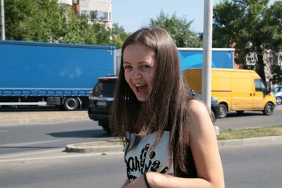 Young woman standing against the sky