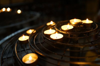 Close-up of lit candles in temple