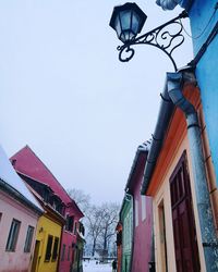 Low angle view of buildings against clear sky during winter