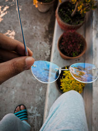 Low section of woman holding multi colored lights