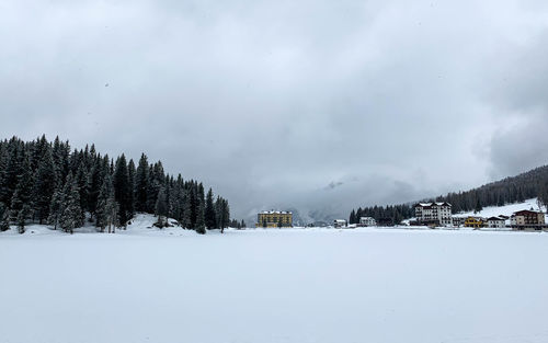 Snow covered land against sky