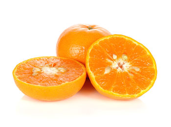 Close-up of orange fruit against white background