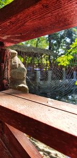 High angle view of wooden structure by lake on sunny day