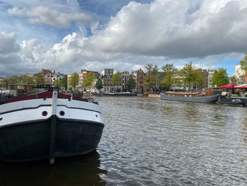 Scenic view of river by city against sky