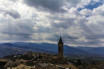 Cityscape against cloudy sky