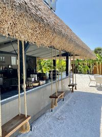 Chairs and table by swimming pool outside house