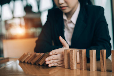 Midsection of woman playing on table