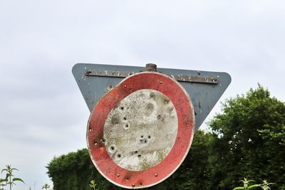 Low angle view of old rusty metal against sky