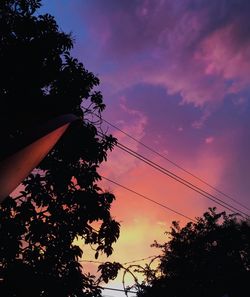 Low angle view of silhouette trees against sky at sunset