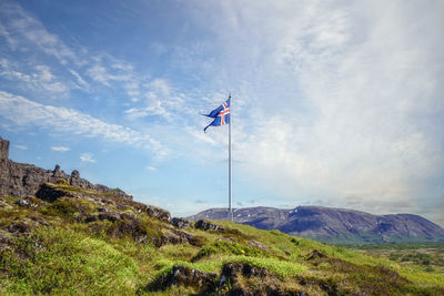 Low angle view of flag against mountain