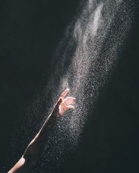 Close-up of hand against black background