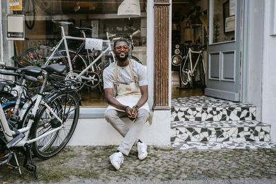 Portrait of young man sitting on bicycle