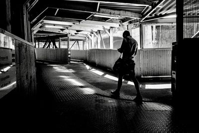 Rear view of man walking in bus