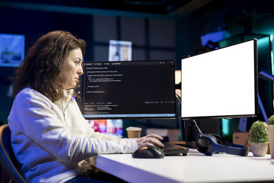 Young woman using laptop at office